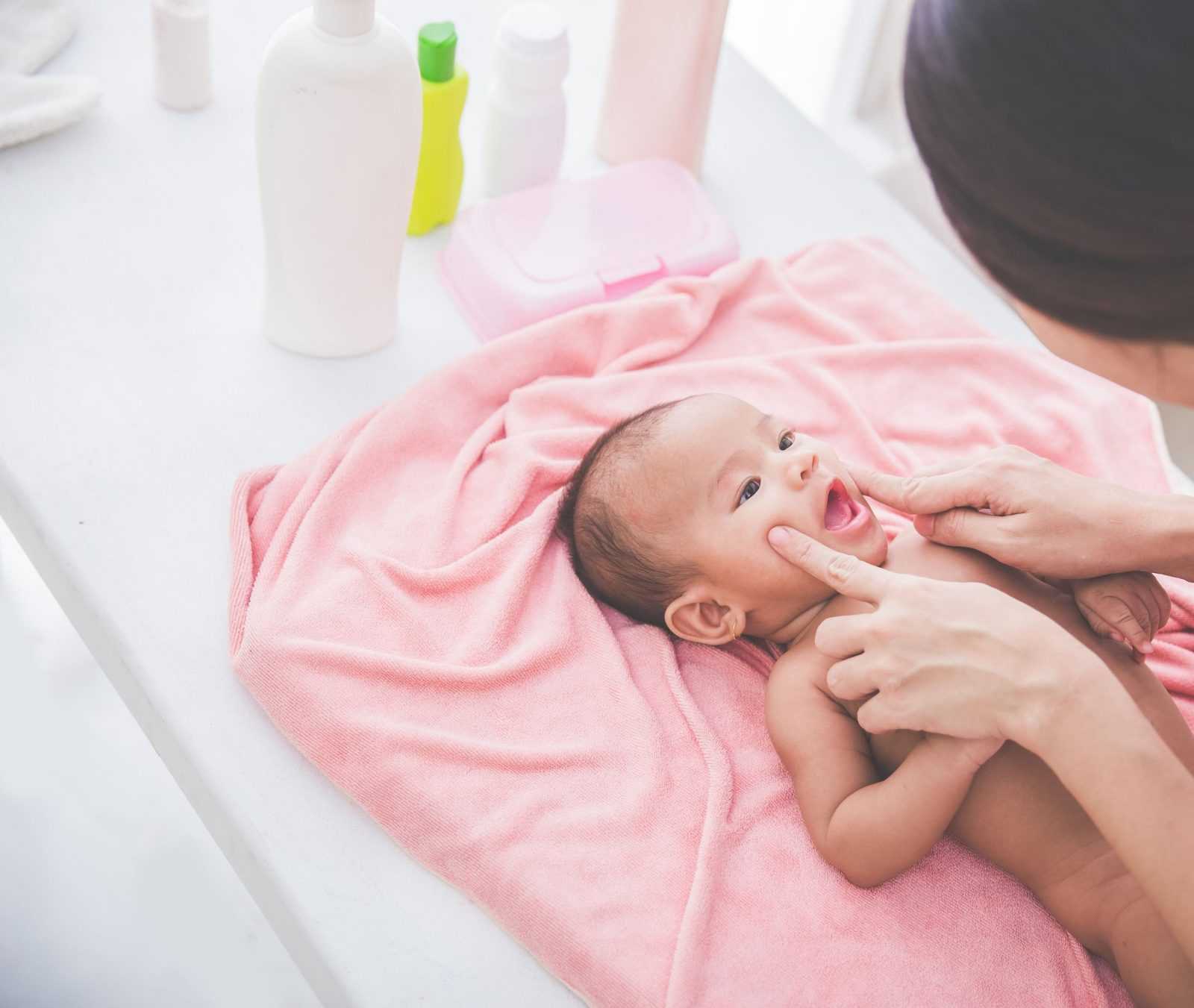 happy baby playing with her mother after being bahted
